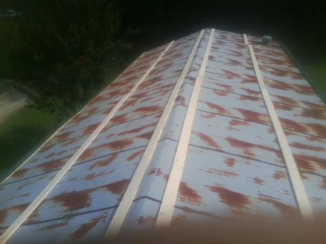 Rusted metal roof panels with new wood purlins before replacement — Storm Damage Roof Repair in Altamont by Roofing Brothers